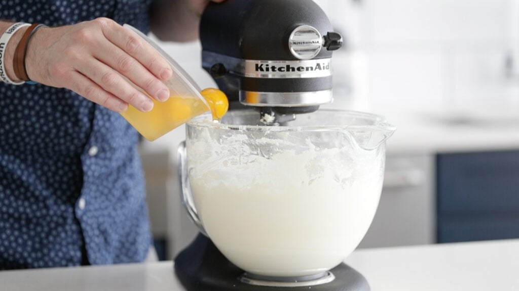 Adding eggs to cream