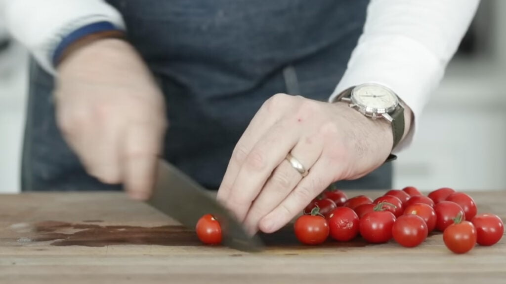 slicing cherry tomatoes in half