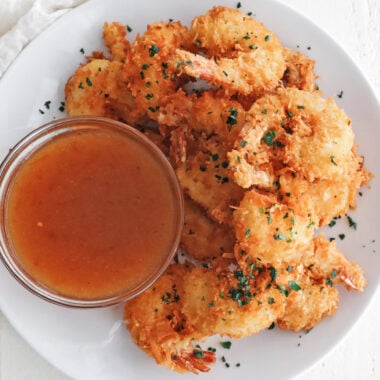 coconut shrimp on a plate with dipping sauce