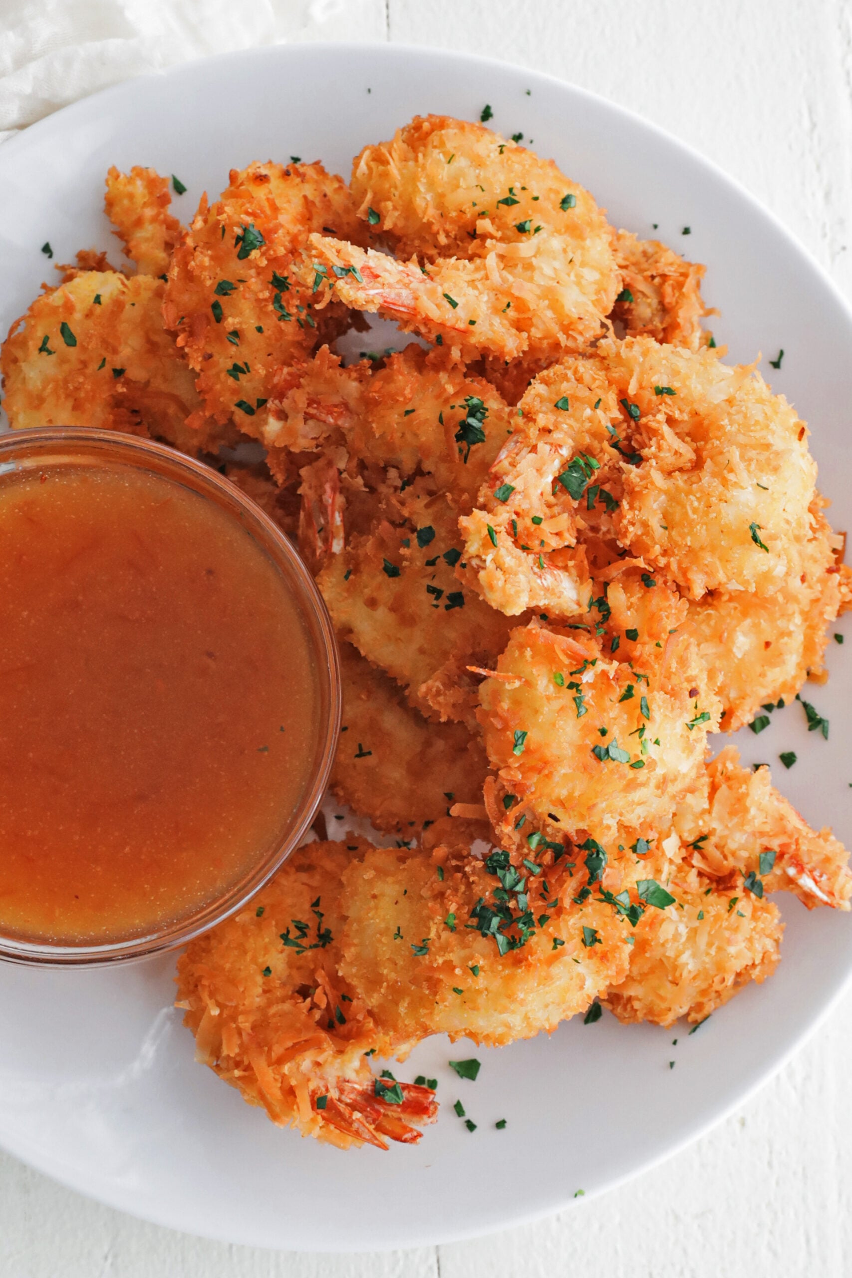 coconut shrimp on a plate with dipping sauce