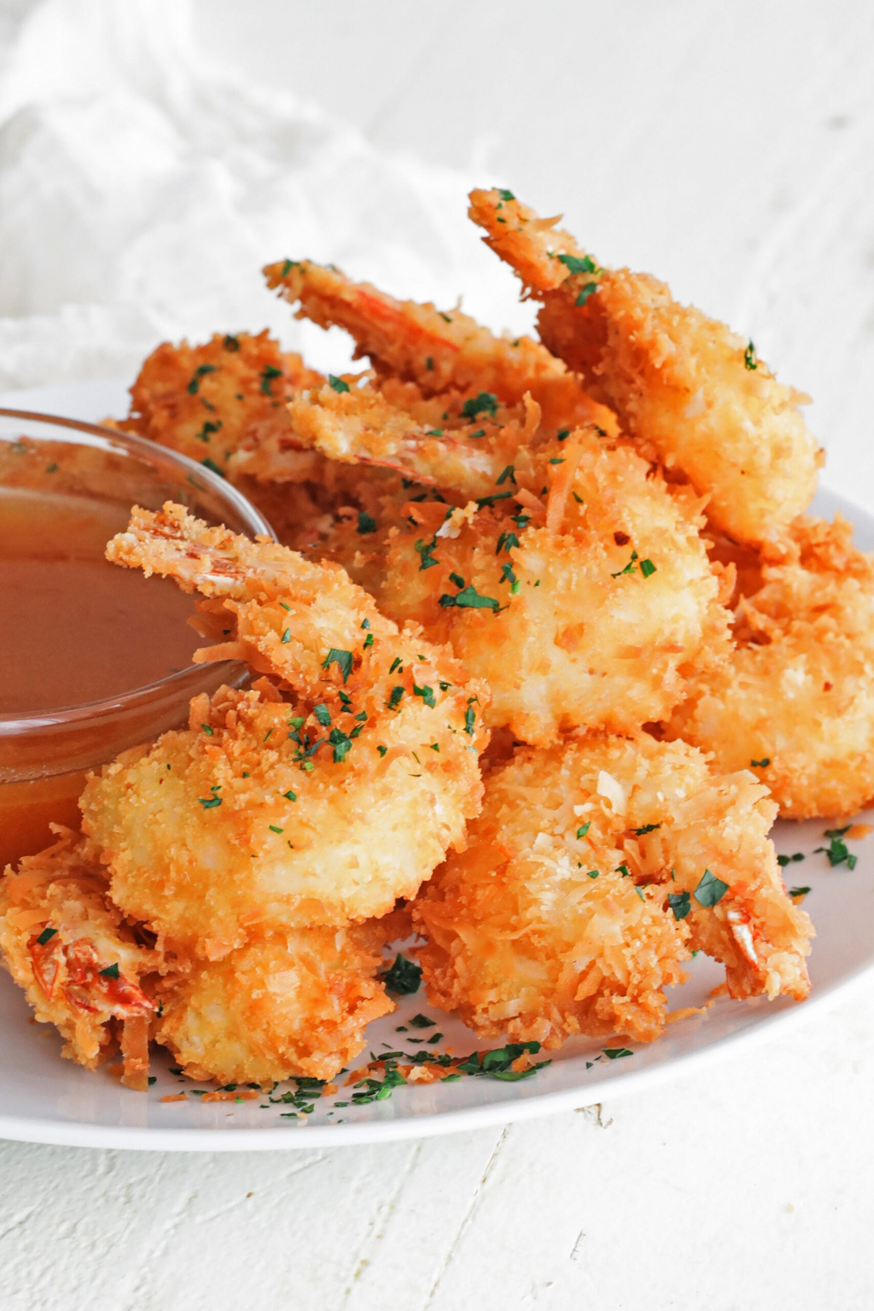 coconut shrimp on a plate with dipping sauce
