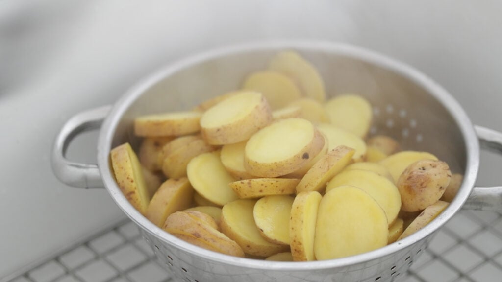 draining cooked potatoes in a colander
