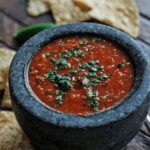 Salsa roja in a small black serving bowl