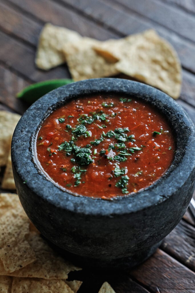 Salsa roja in a small black serving bowl