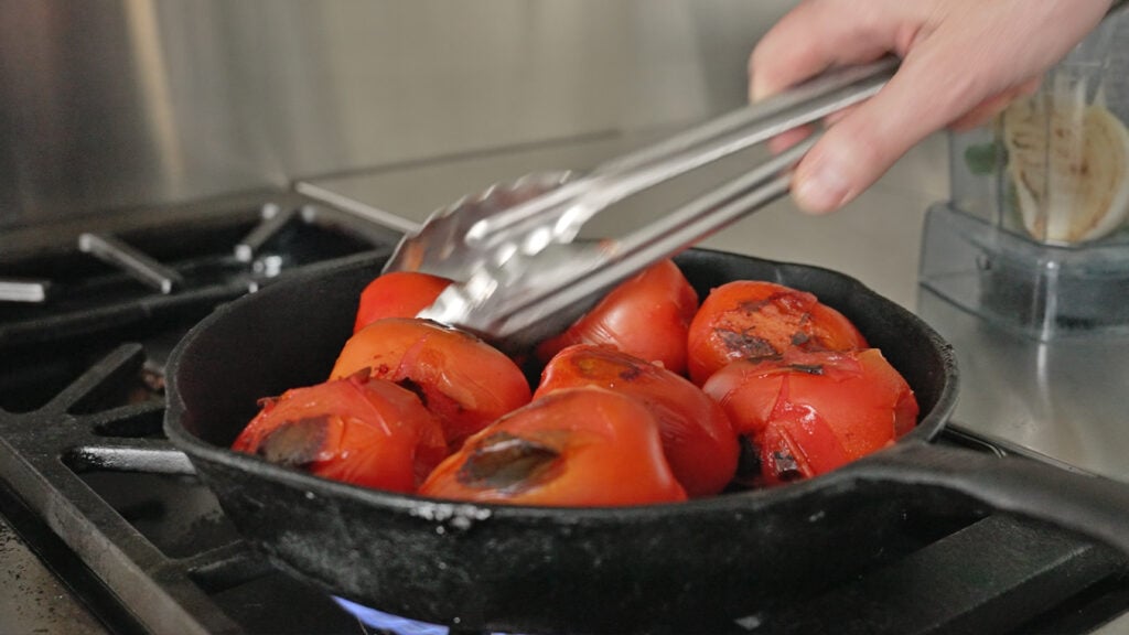 charring tomatoes in a skillet