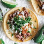 Steak Taco with lime wedges around it
