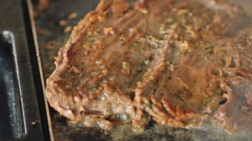 steak searing on hot griddle