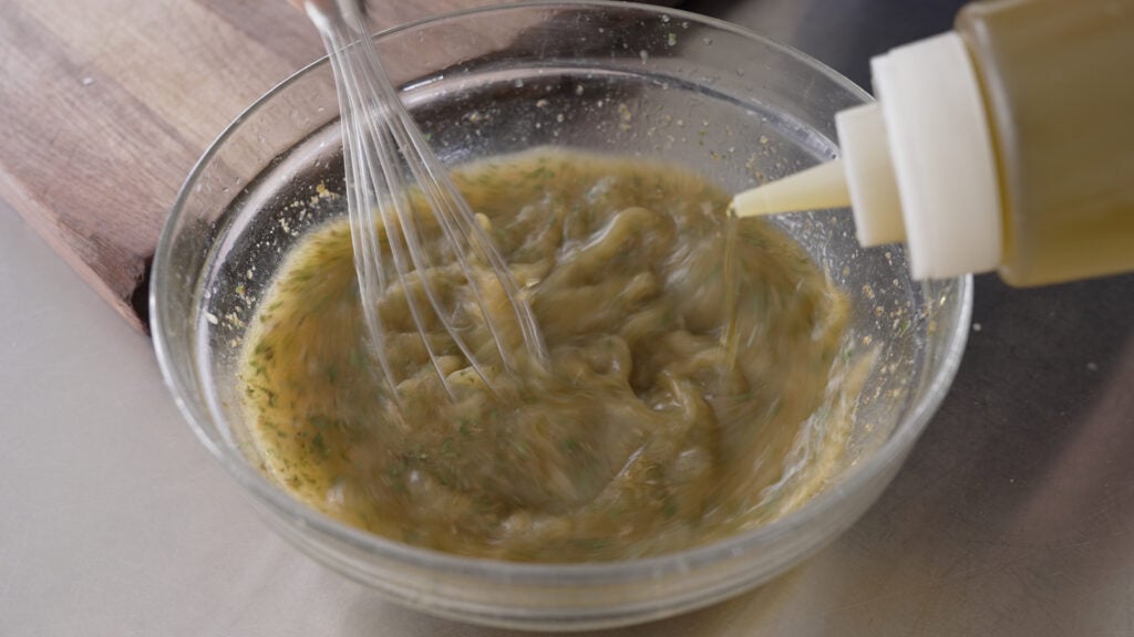 using a wisk to incorporate oil into marinade ingredients 