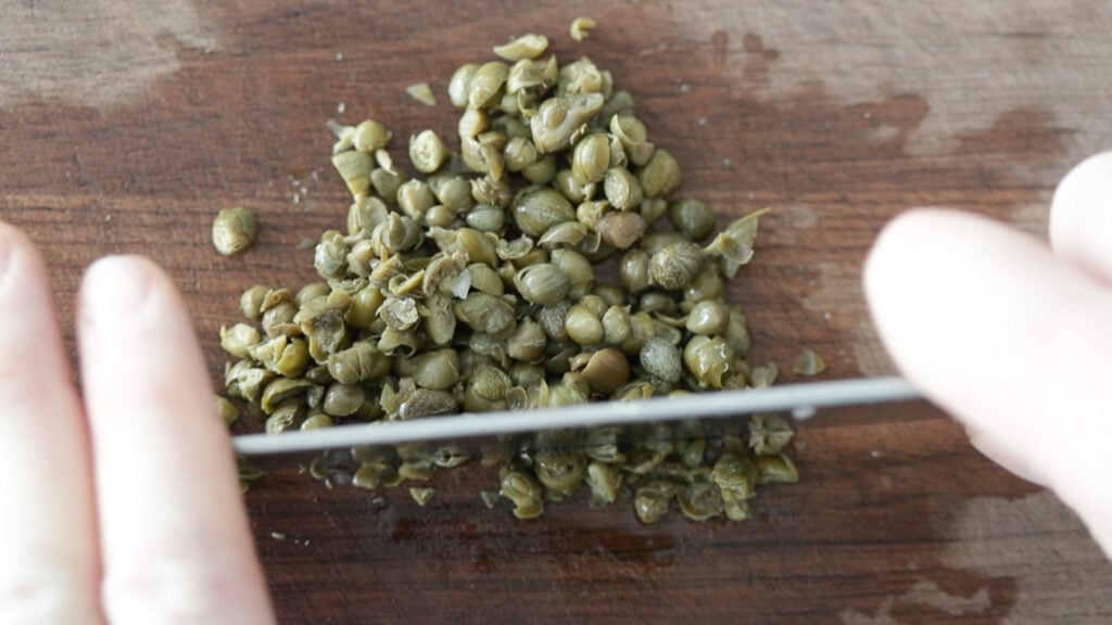 finely chopping capers