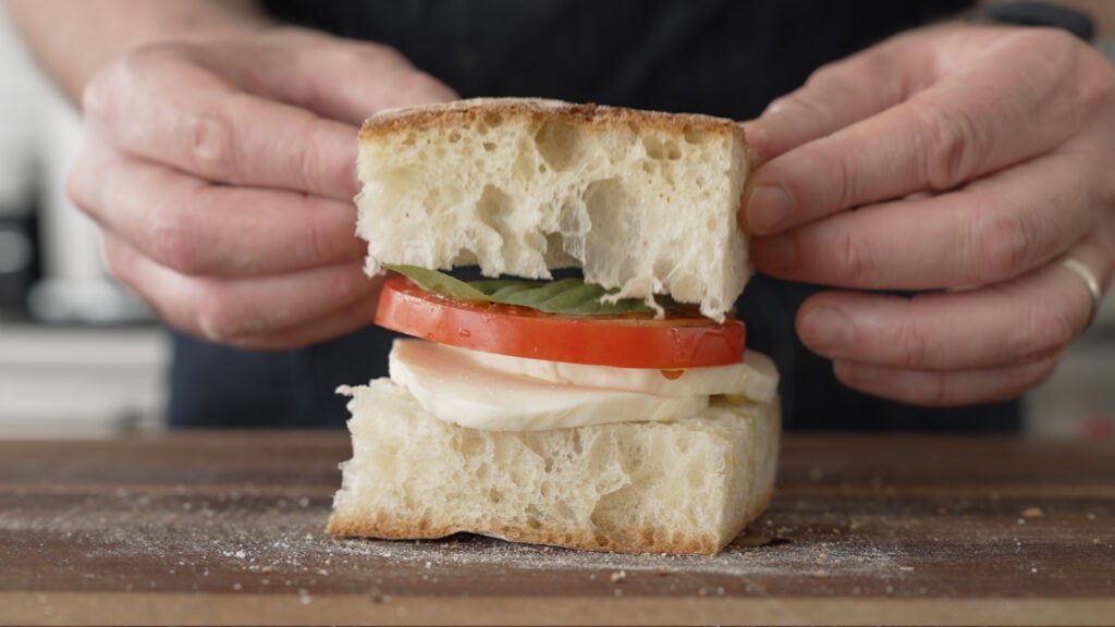placing the top piece of bread on the sandwich