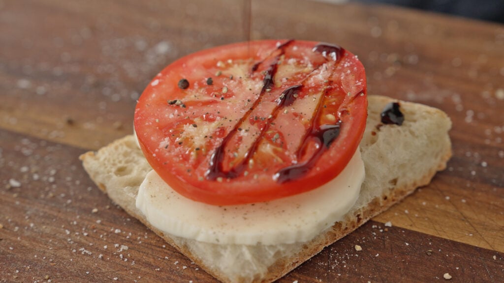 Tomato on the sandwich with a drizzle of balsamic reduction
