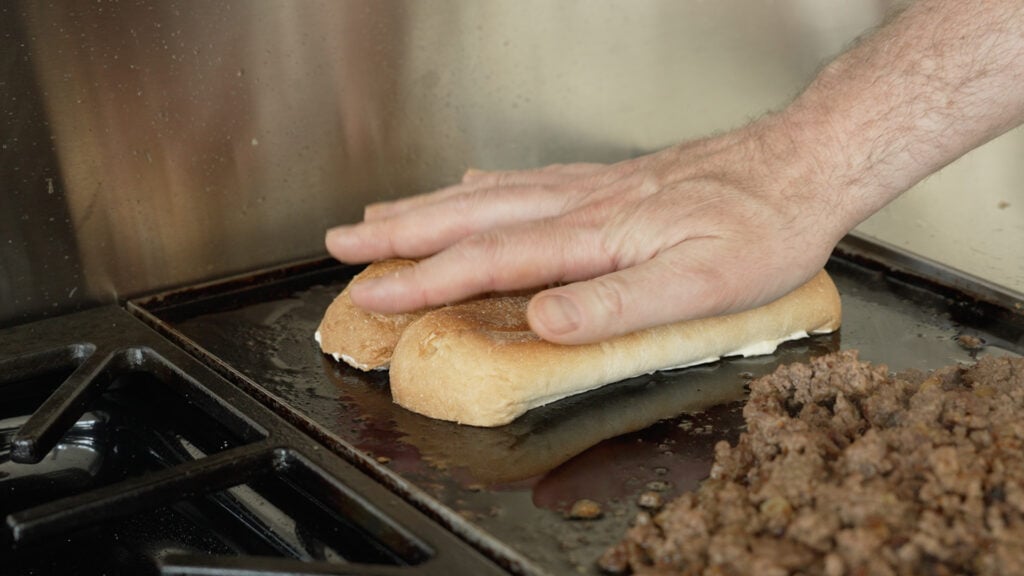 Toasting a sandwich roll on a griddle