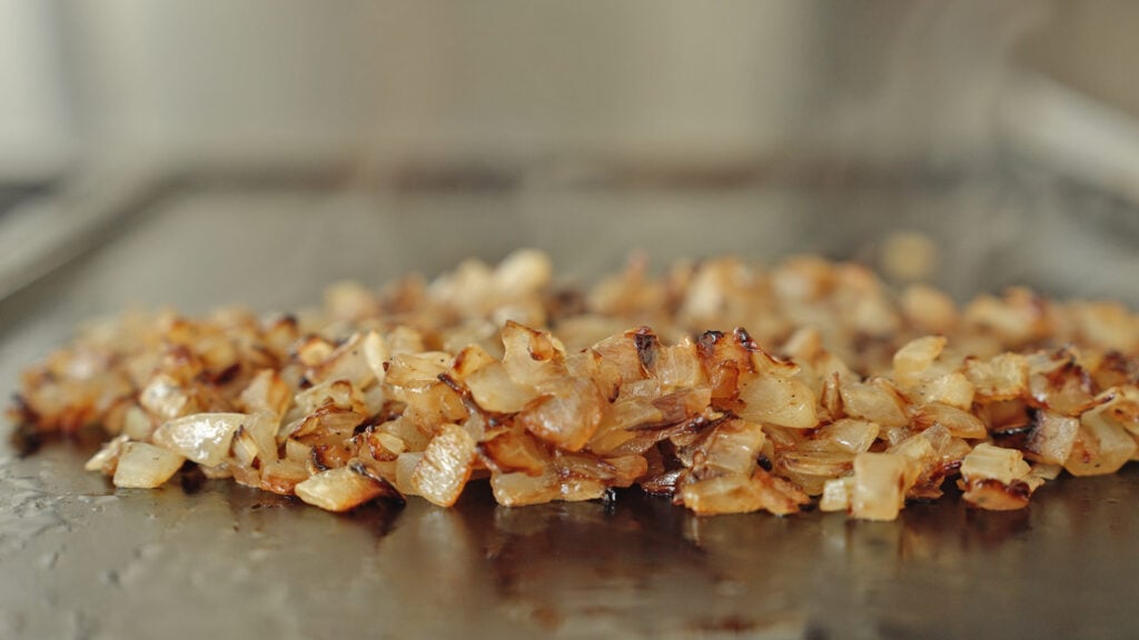 browned onions on a griddle 