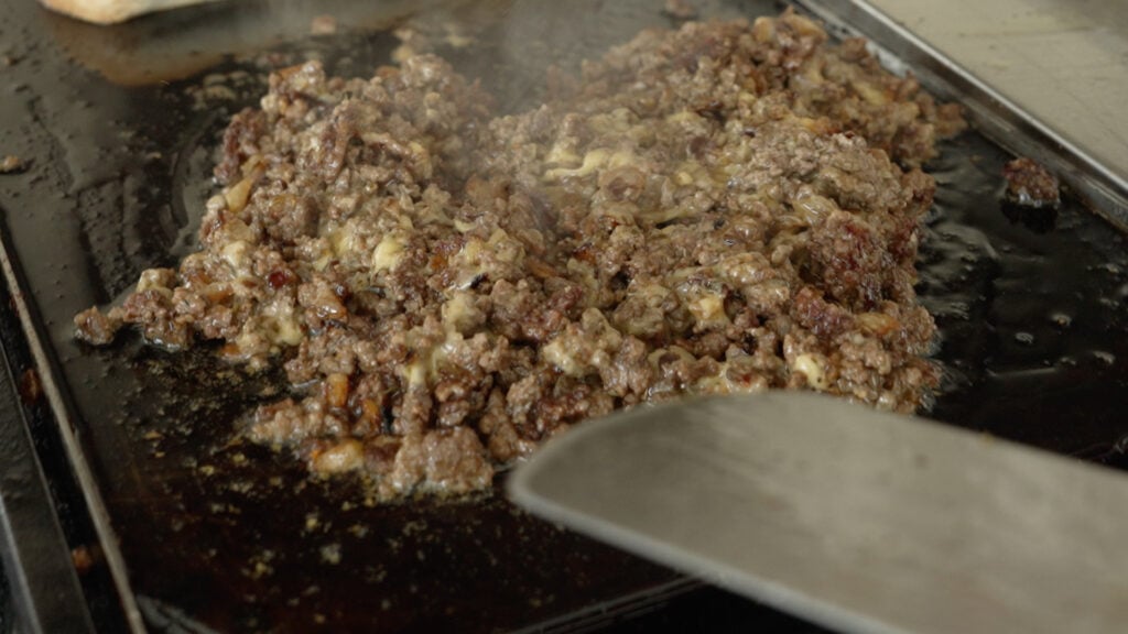 Ground beef mixed with cheese all chopped up
