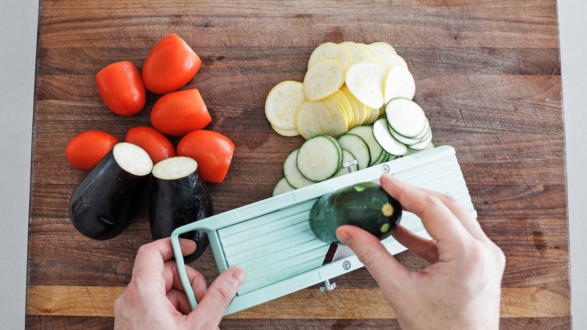 slicing veggies on a mandolin