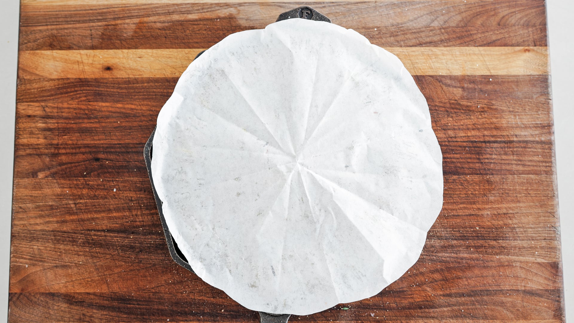 parchment paper round over a cast iron skillet