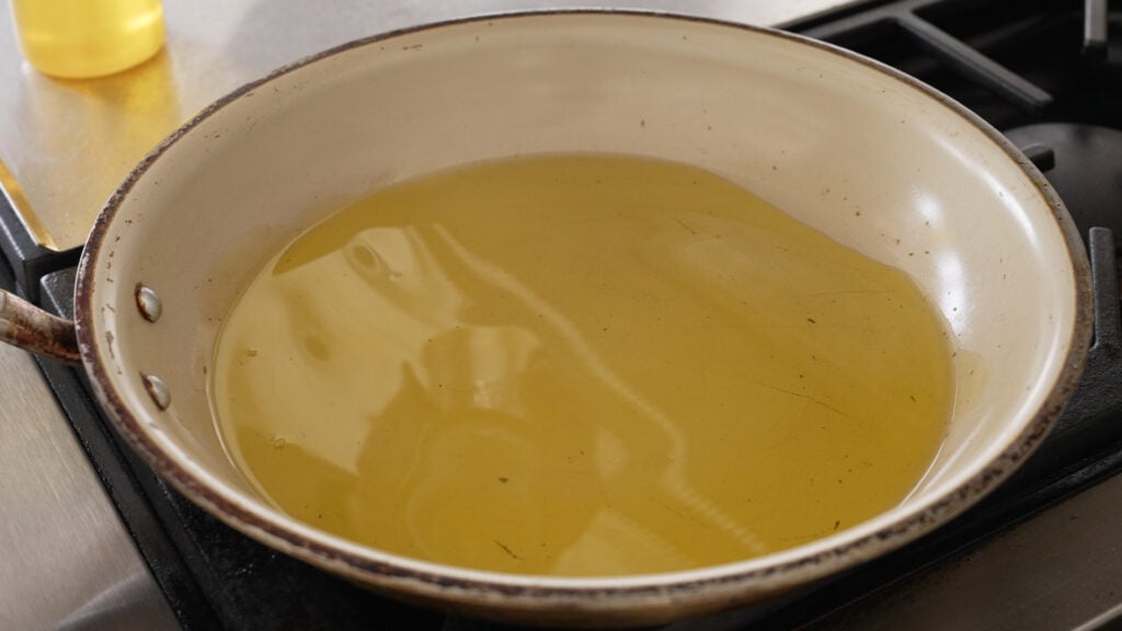heating the oil in a large nonstick skillet