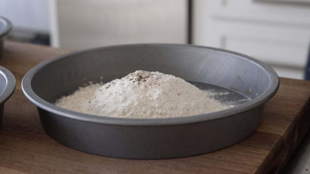 dry breading ingredients in a cake tin 