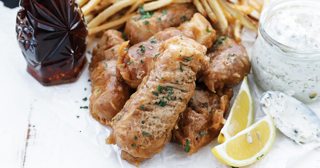 fish and chips plated with tartar sauce