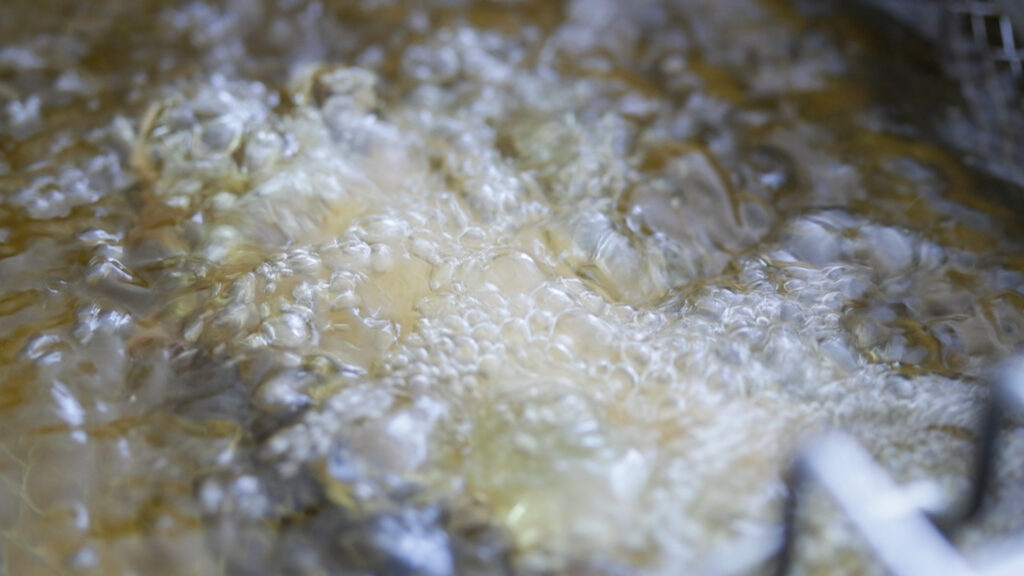 battered fish frying in hot oil