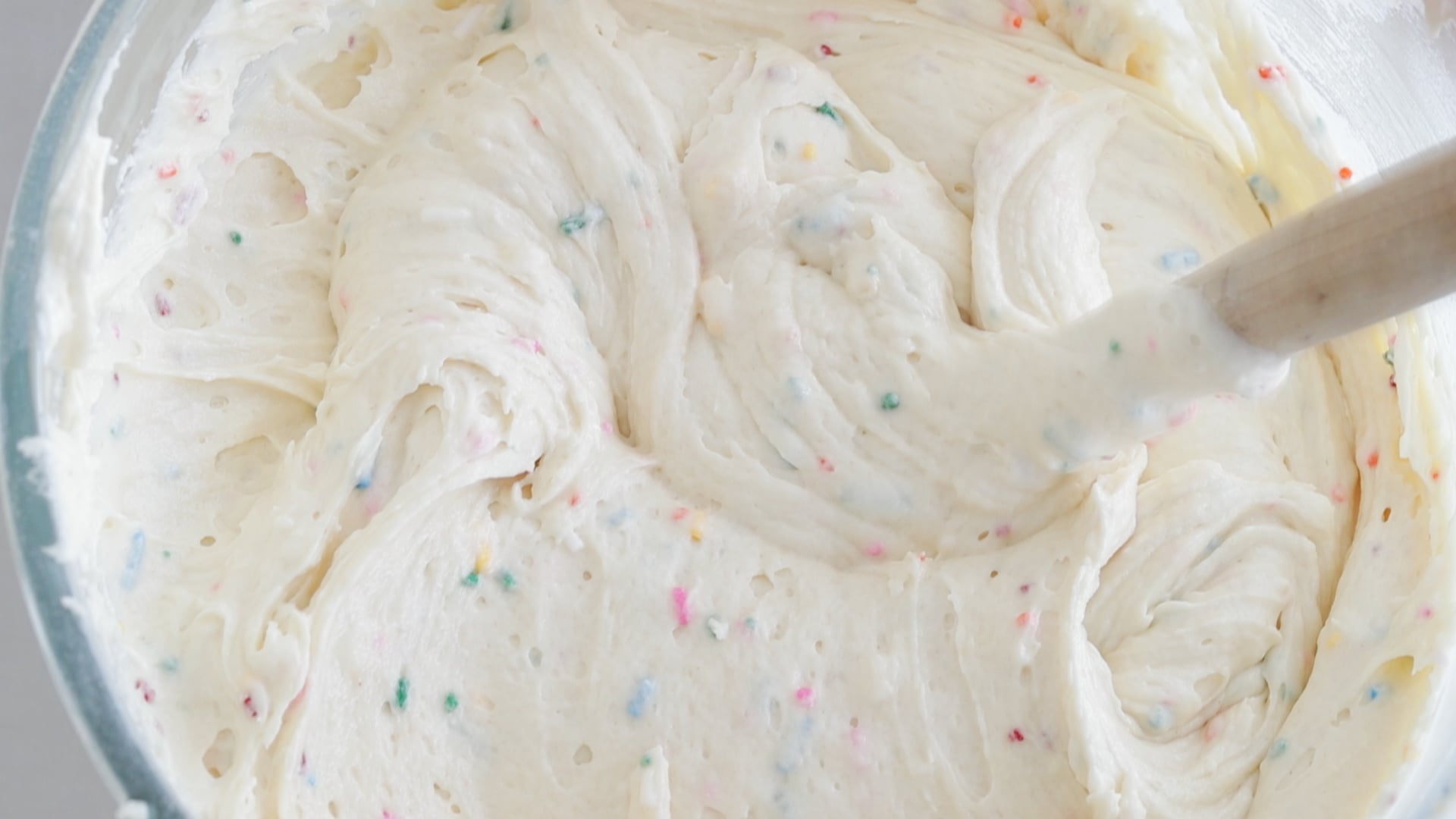 mixing sprinkles into a cake