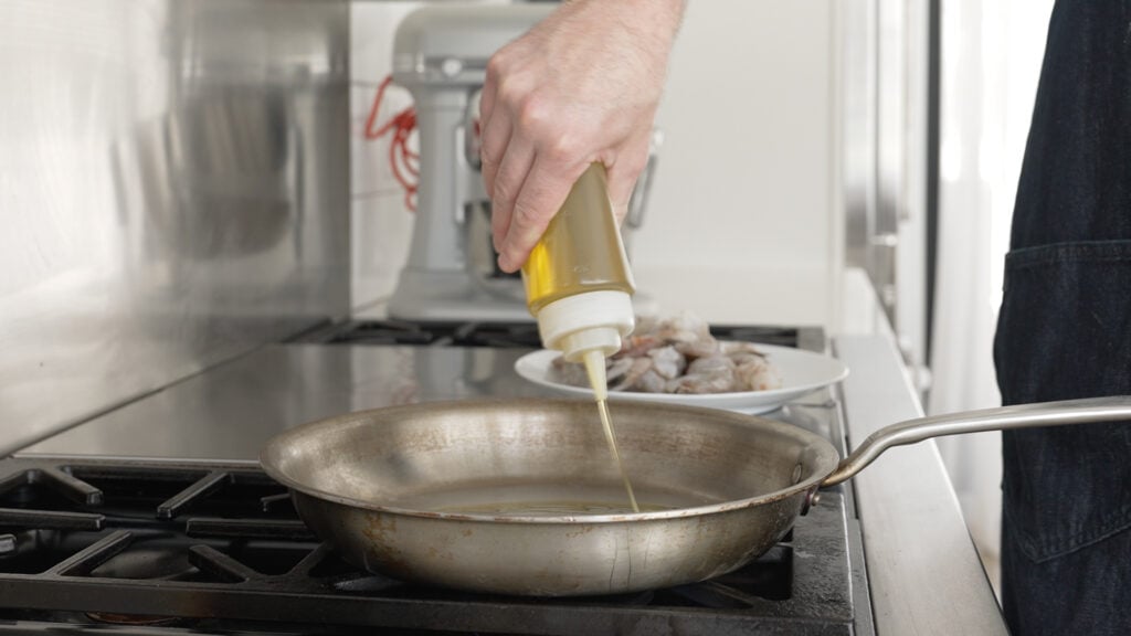 pouring oil into a pan