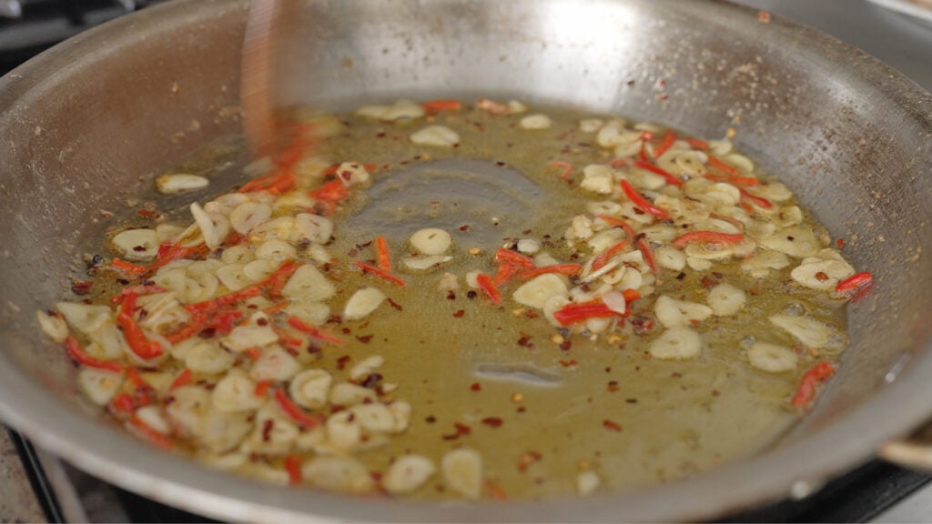 peppers added to the pan with garlic