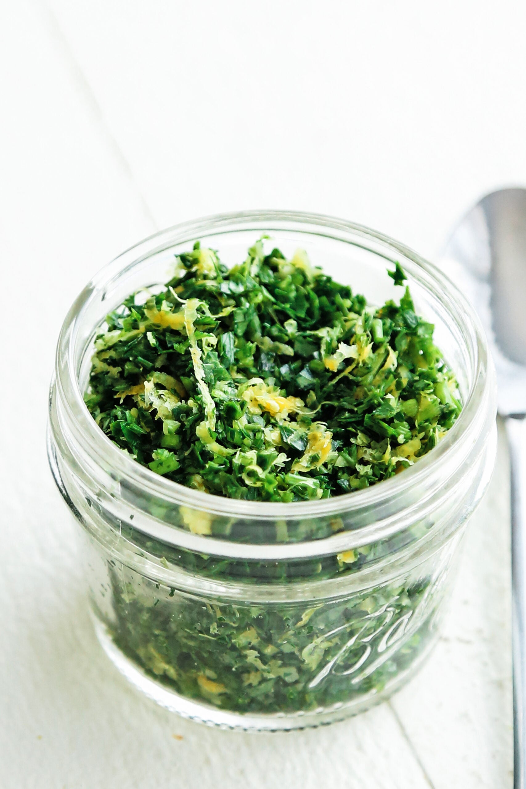 parsley and garlic in a jar with lemon zest