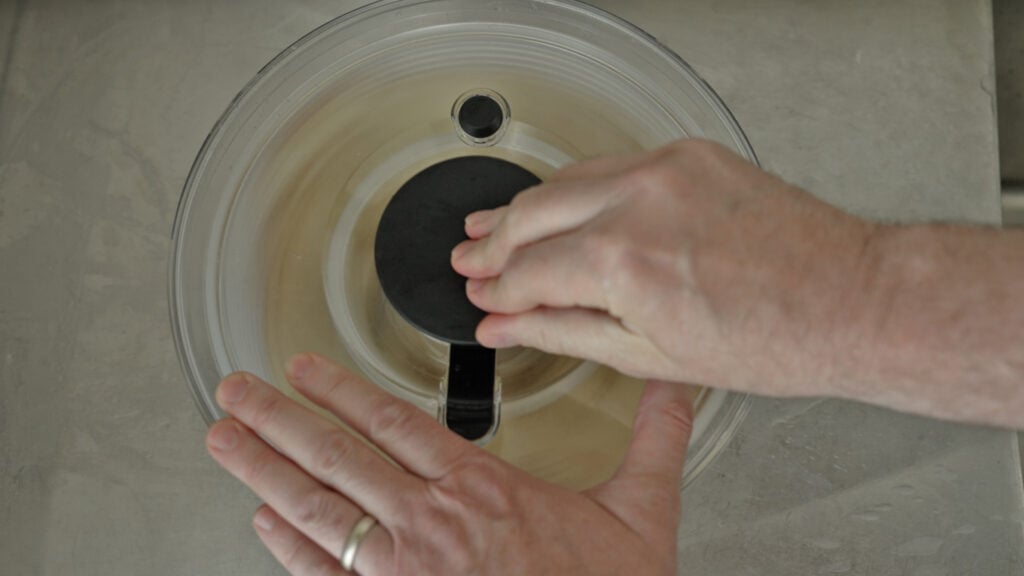 using a salad spinner to dry the potato slices