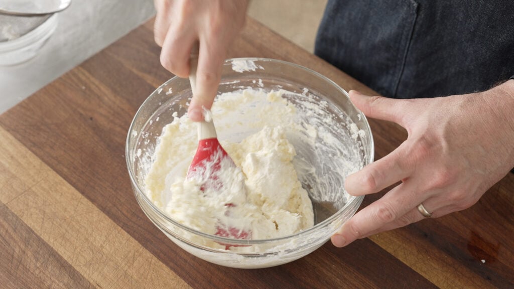 Using a rubber spatula to combine the sauce ingredients