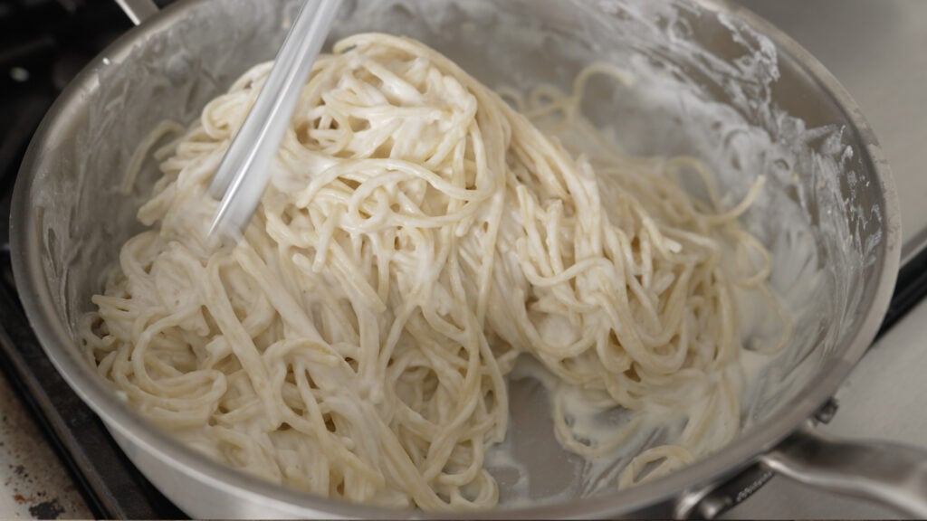 Combining the pasta with sauce