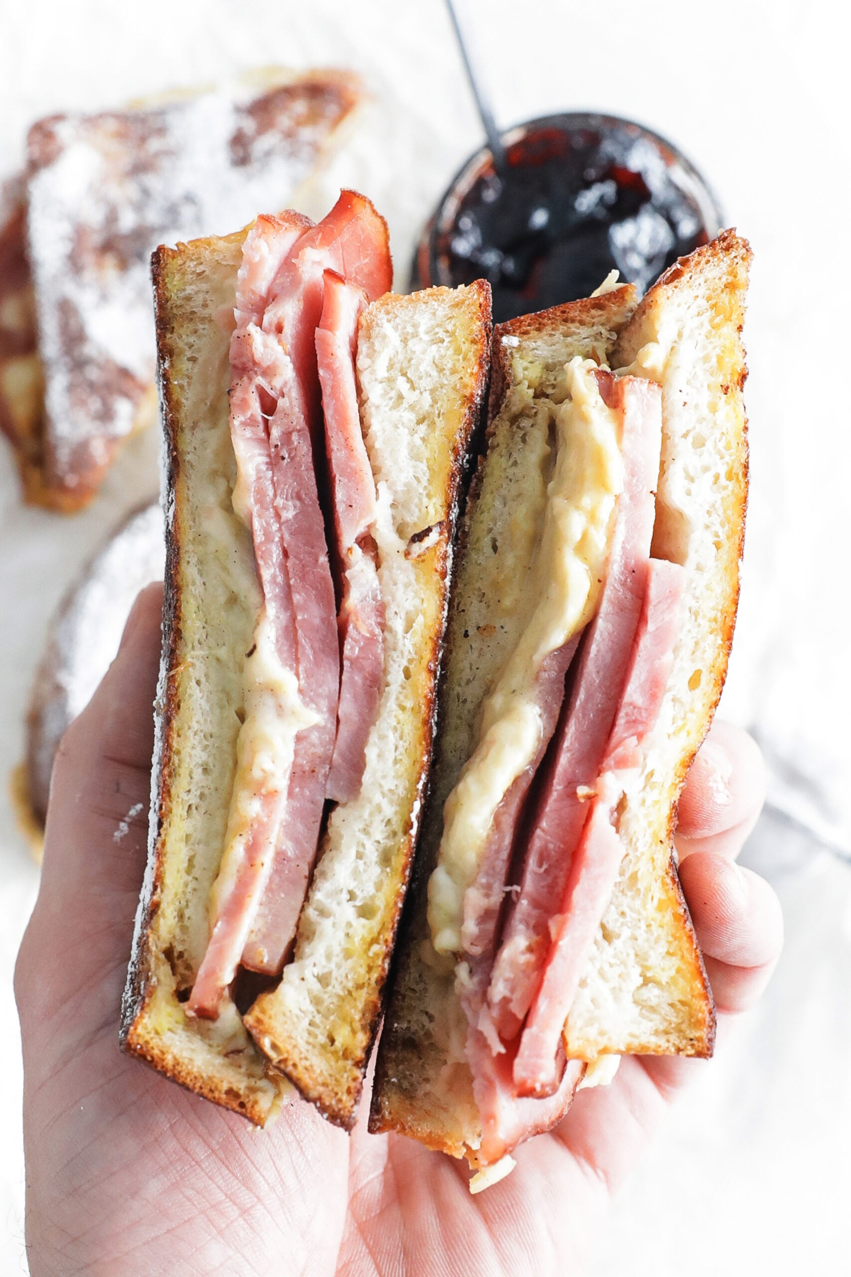 monte cristo sandwich in hand with jam