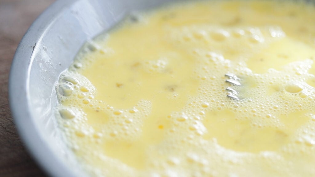 egg batter in a shallow pie tin