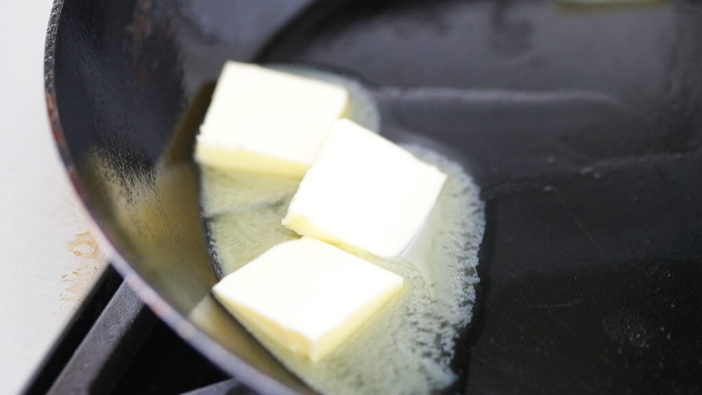 Heat the pan and the butter