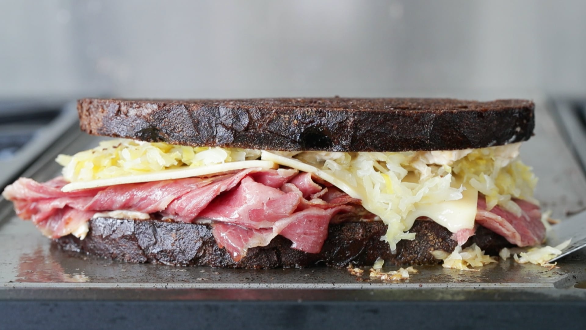 a reuben sandwich on a griddle