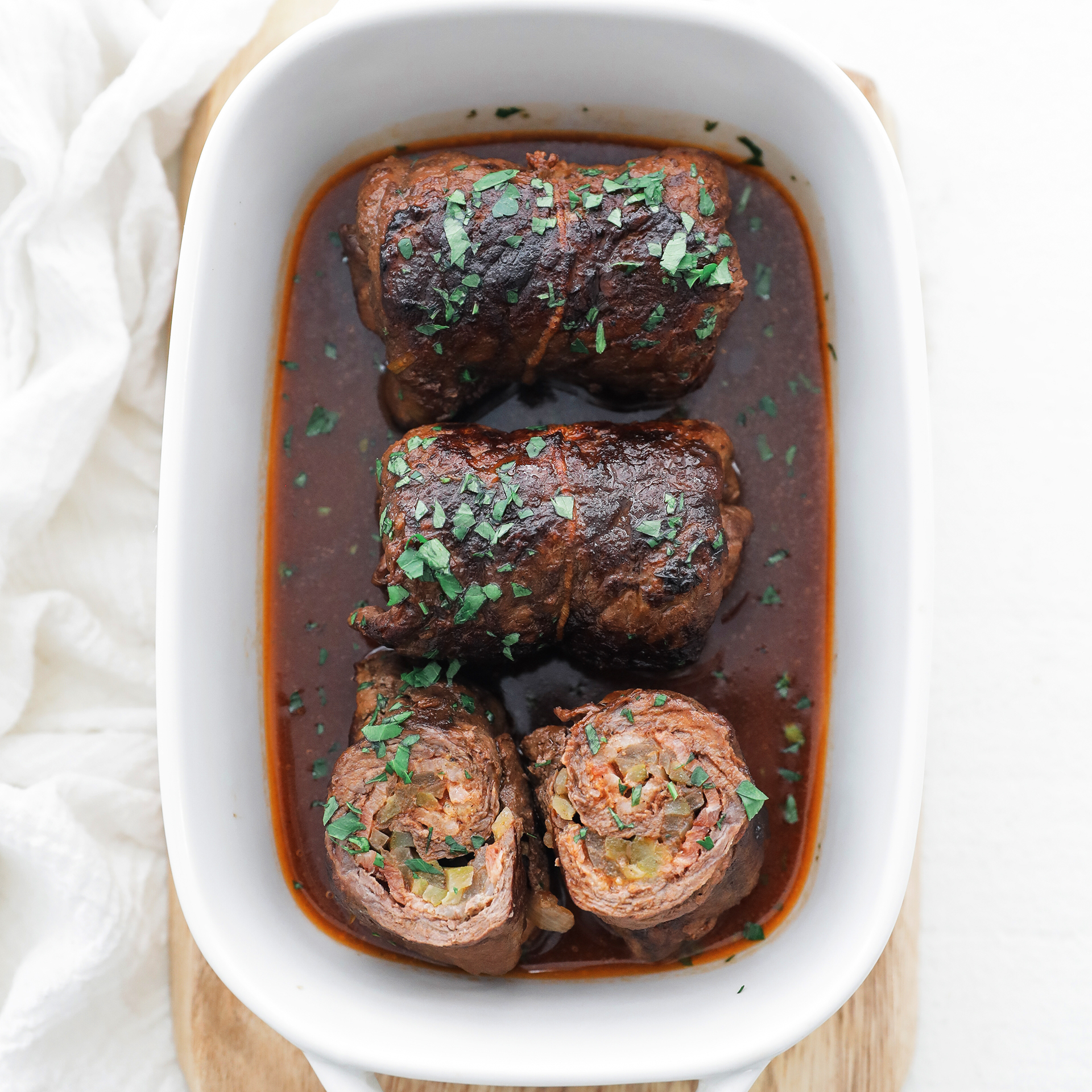 beef rouladen slices in a dish with gravy