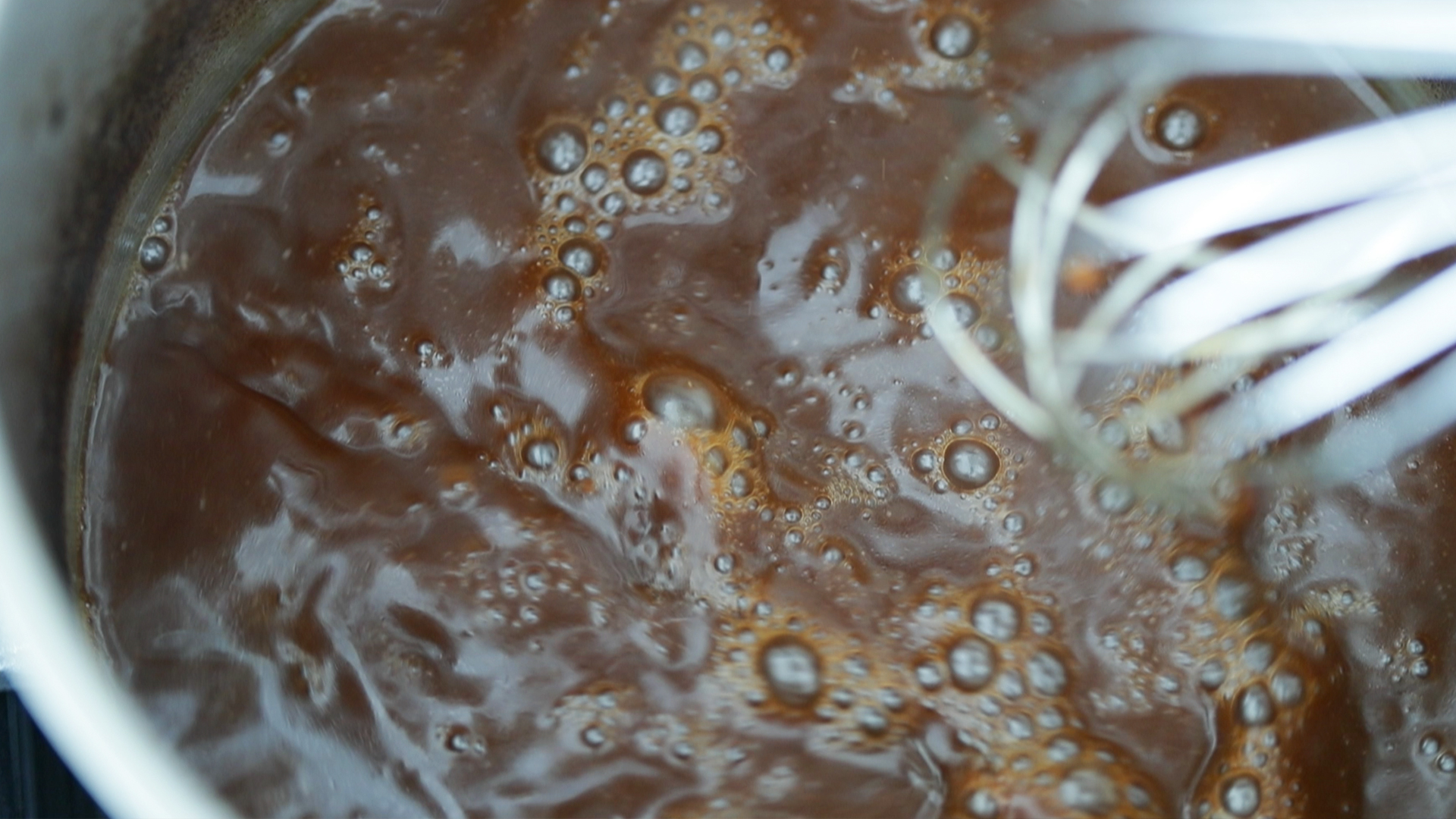 cooking down a beef stock into gravy