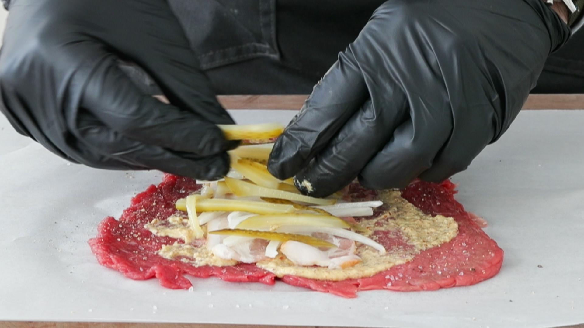 adding pickles onto a beef rouladen