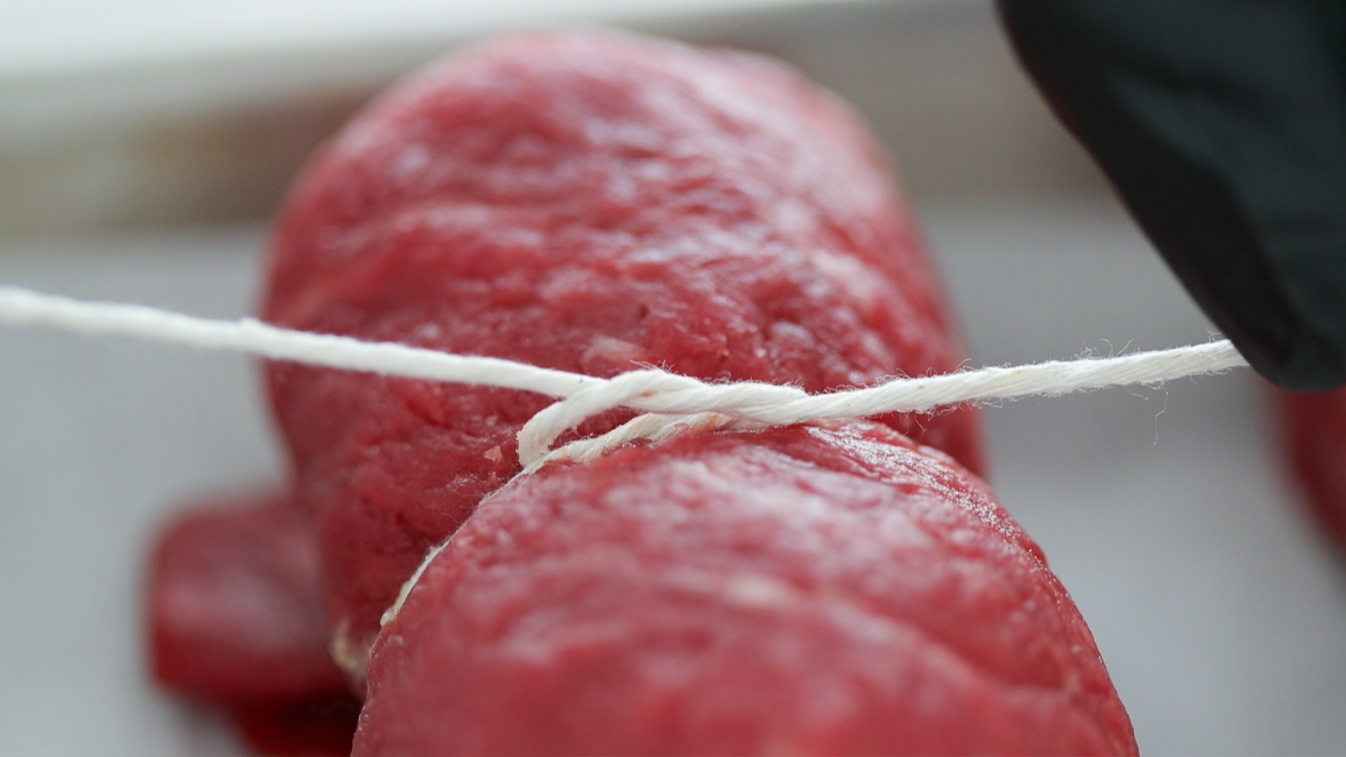 tying twine around beef rouladen