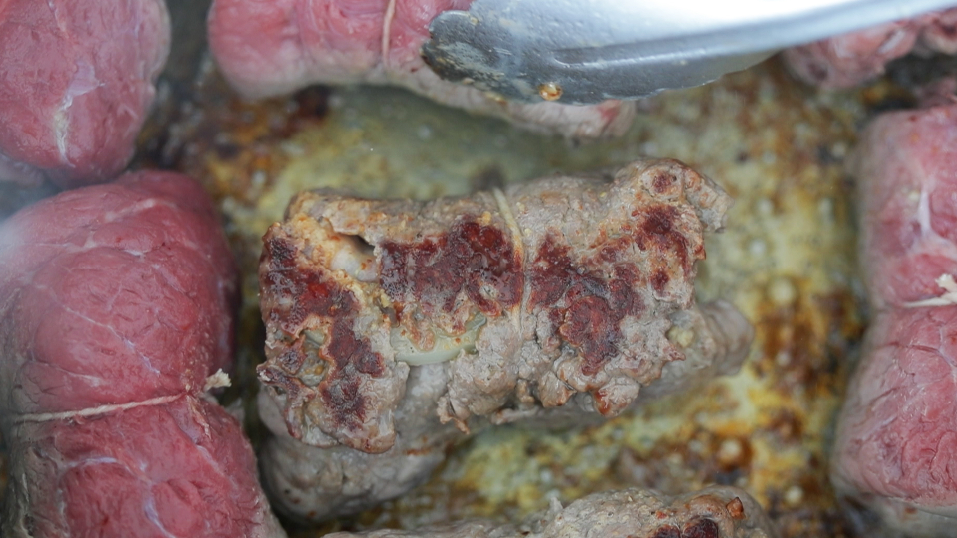 pan searing roulade beef in a pan