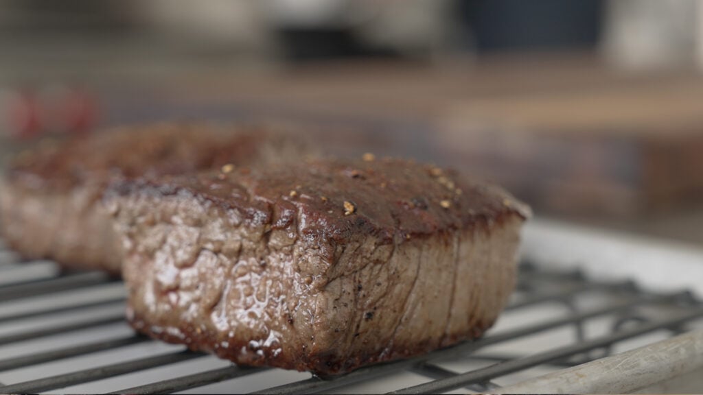 beef resting on a wire rack