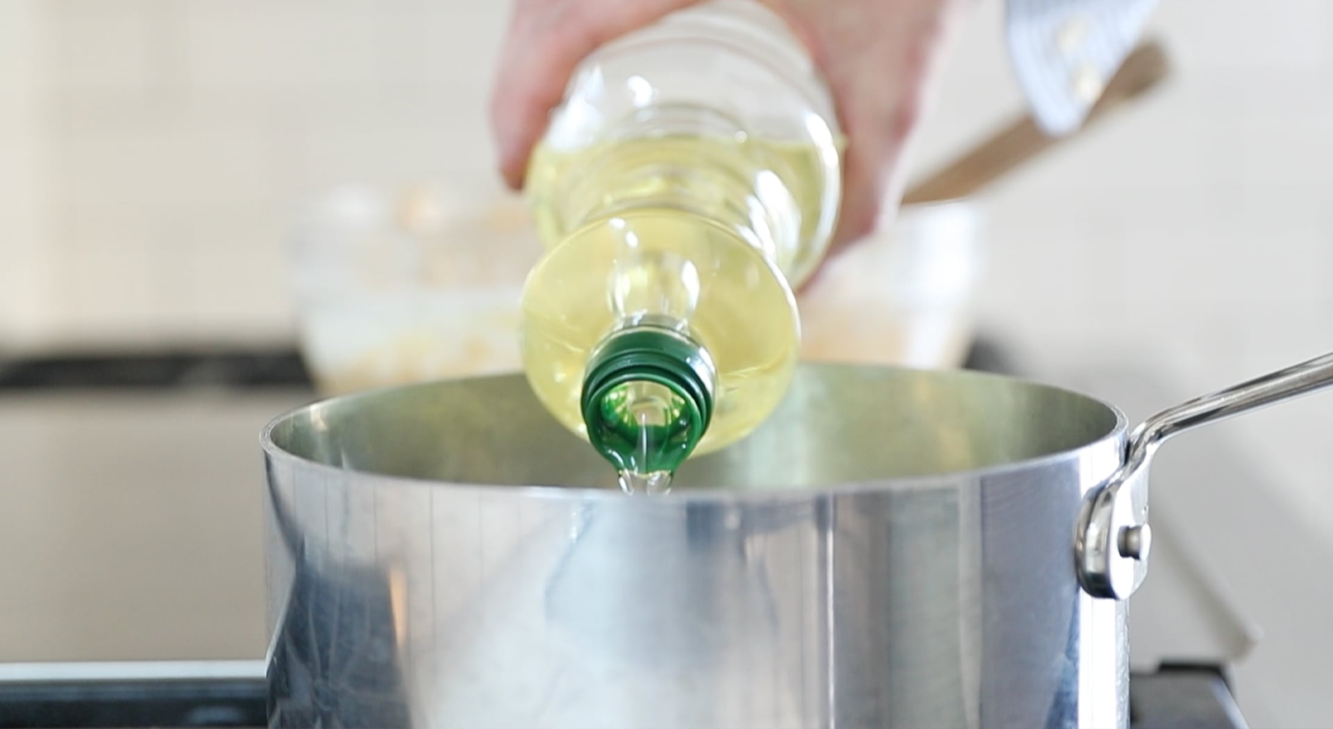 adding oil to a pot