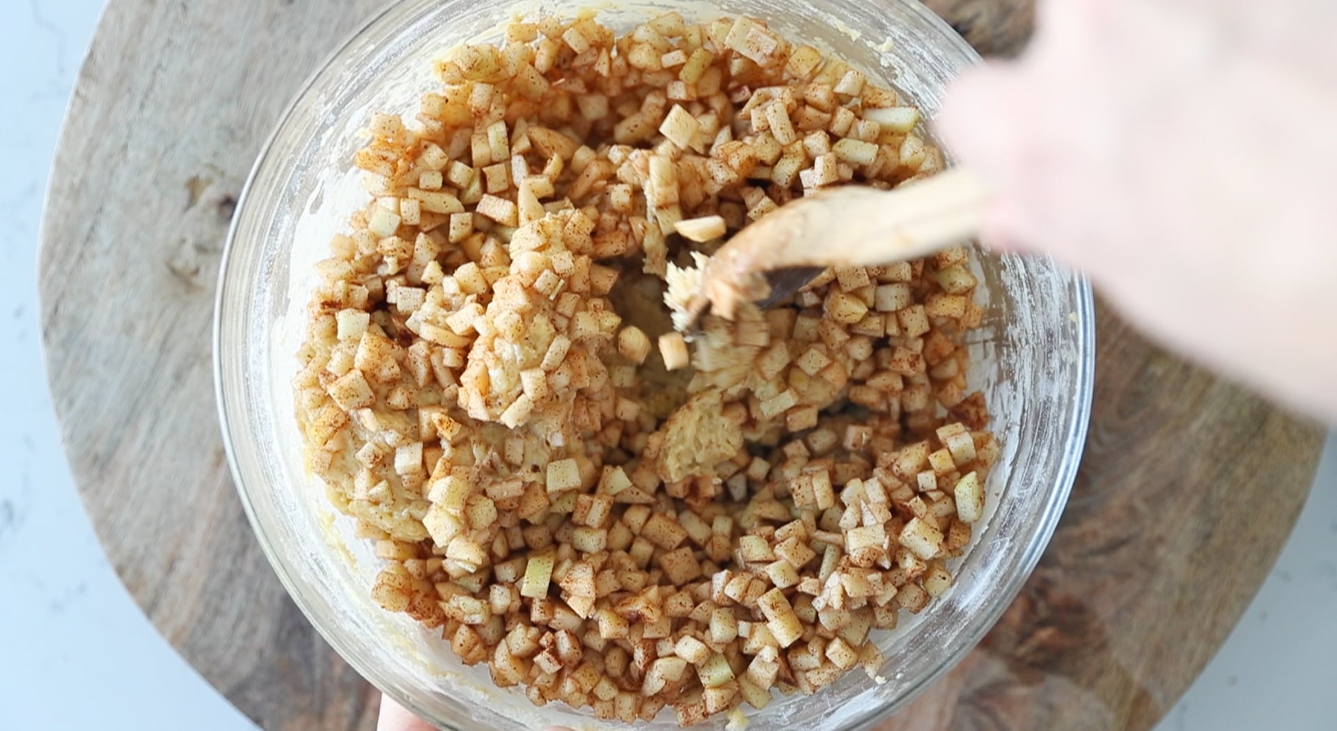 mixing apples with a batter