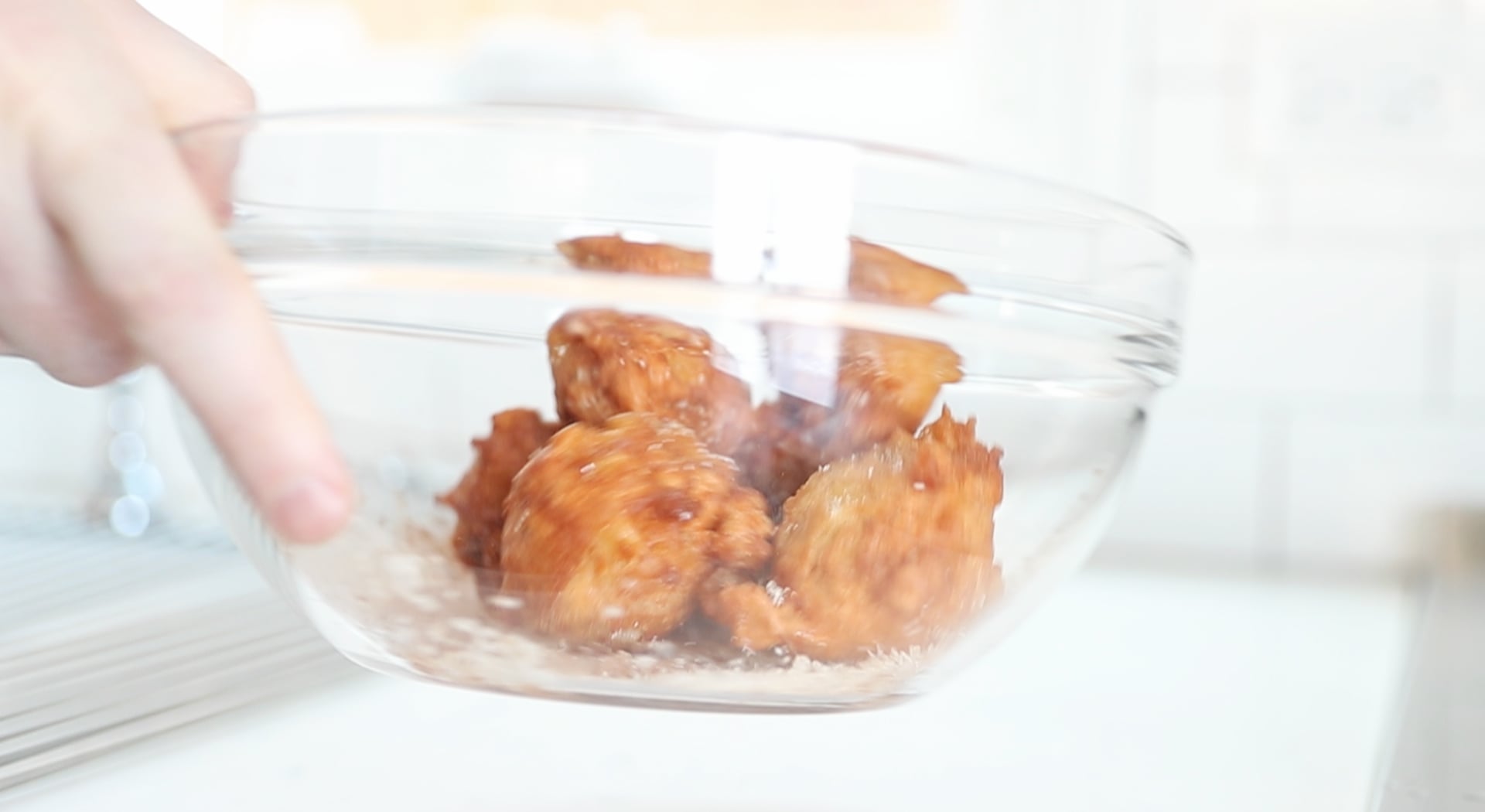 tossing apple fritters with cinnamon and sugar