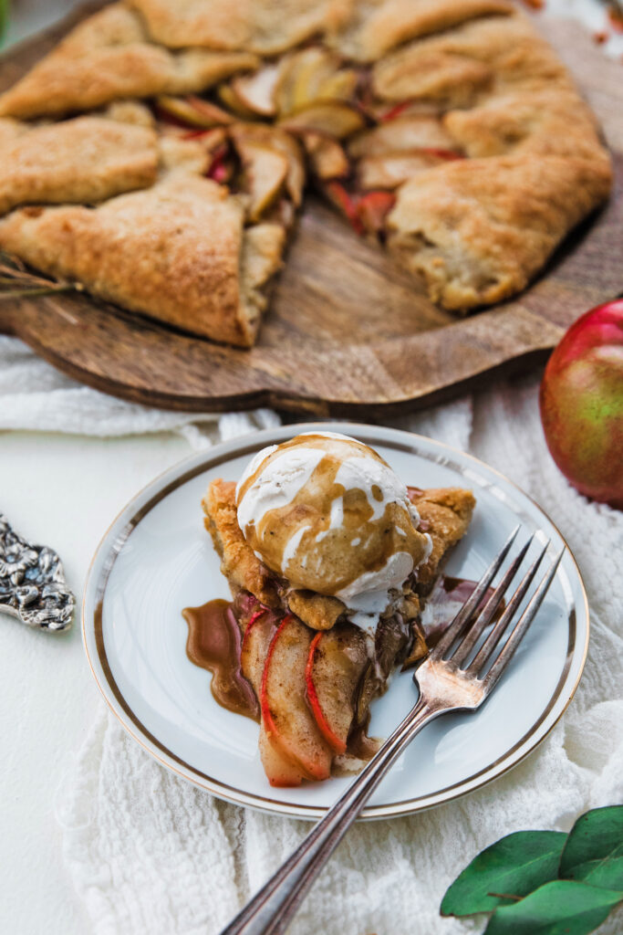 a whole apple galette and a slice with ice cream and caramel
