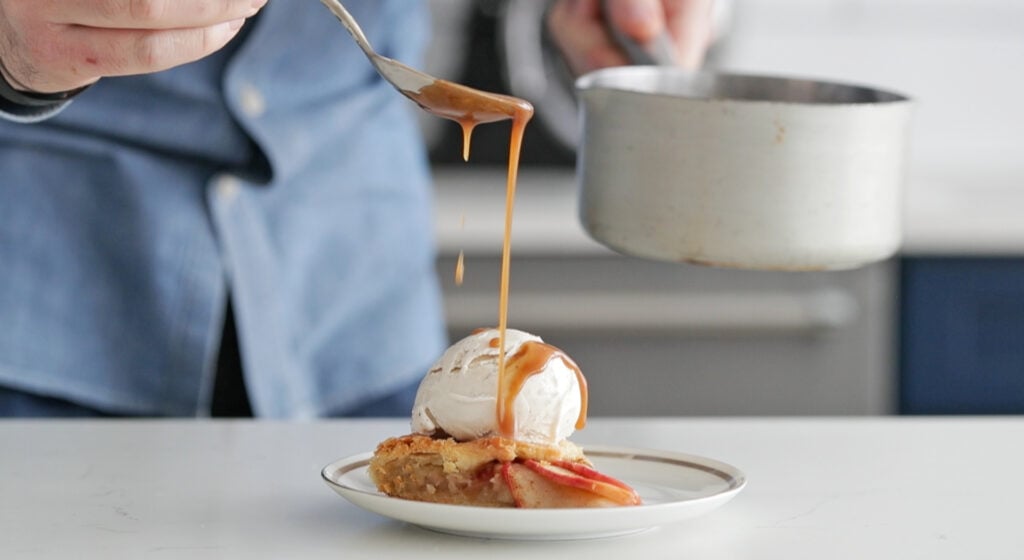 drizzling caramel on top of apple galette