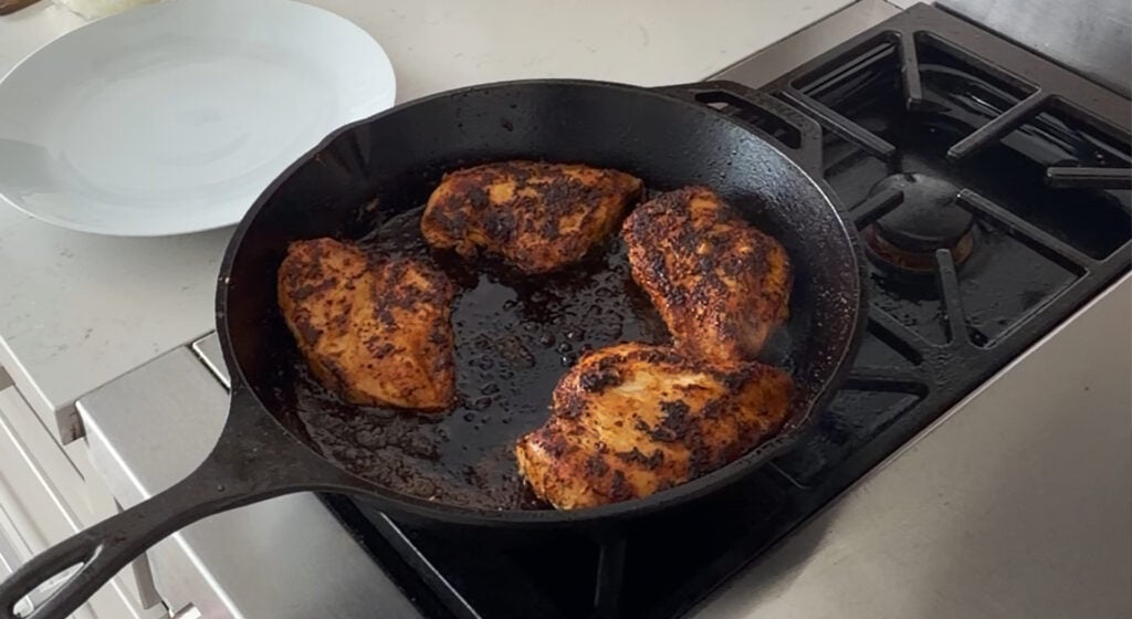 searing the chicken breasts in a skillet