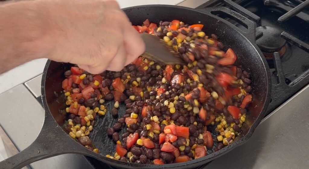 cooking the beans and tomatoes with veggies