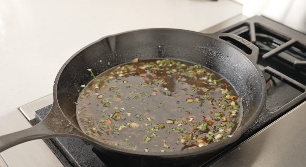 stirring honey to finish sauce in a skillet