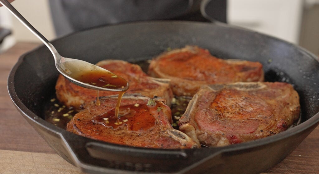 spoonful of sauce on top of pork chops